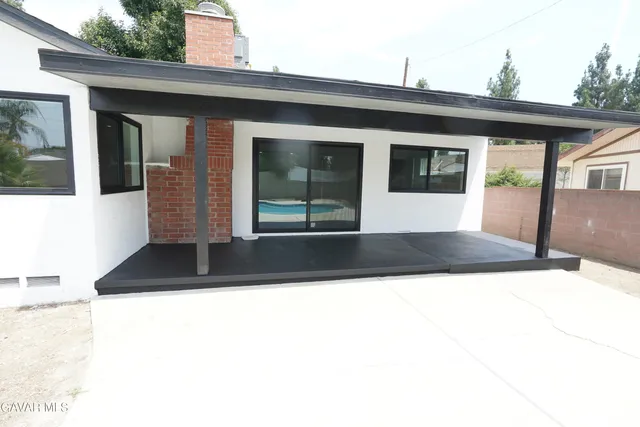 a large kitchen with stainless steel appliances kitchen island granite countertop a stove a sink and a granite counter tops