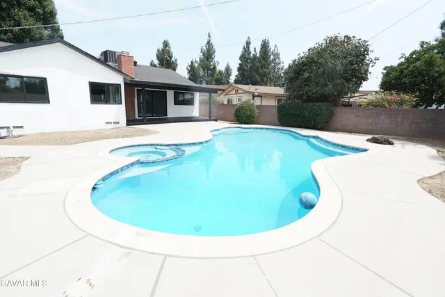 a view of a hallway with wooden cabinets and staircase
