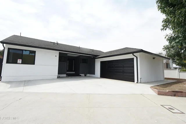 a spacious bathroom with a sink and a mirror