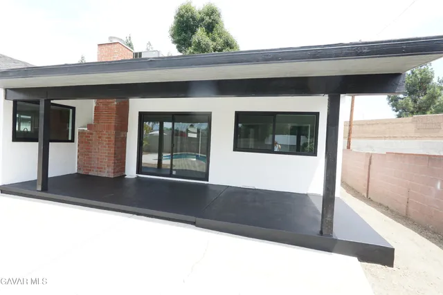 a kitchen with granite countertop a stove and a wooden floors