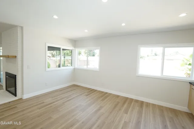 a view of a hallway with wooden floor and a large window