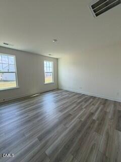 706 Old Station Angier, NC 27501 - Photo 3 of 19 an empty room with wooden floor and windows