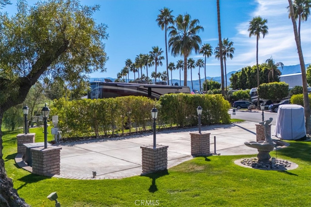 69411 Ramon Road Cathedral City, CA 92234 - Photo 3 of 17 a swimming pool with outdoor seating and trees
