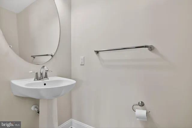 a bathroom with a sink a mirror and shower