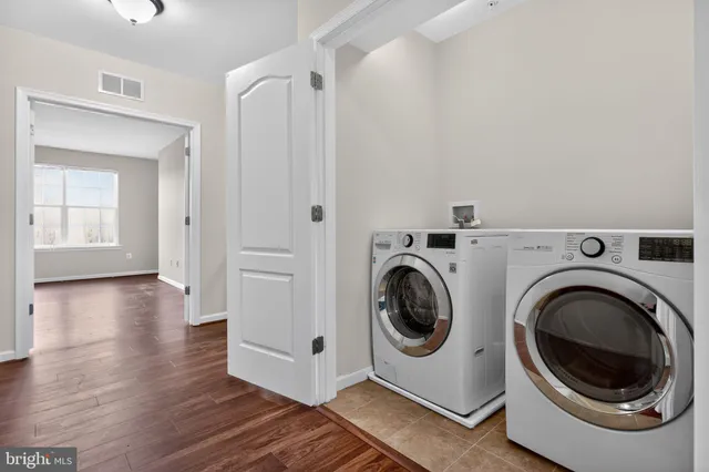 a view of a hallway with washer and dryer