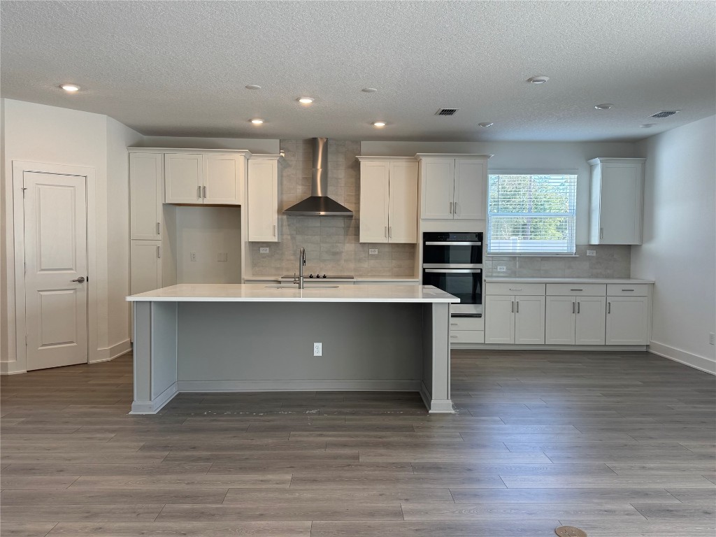96040 Pirates Bluff Road Yulee, FL 32097 - Photo 4 of 10 a large kitchen with stainless steel appliances granite countertop a stove a sink and a refrigerator