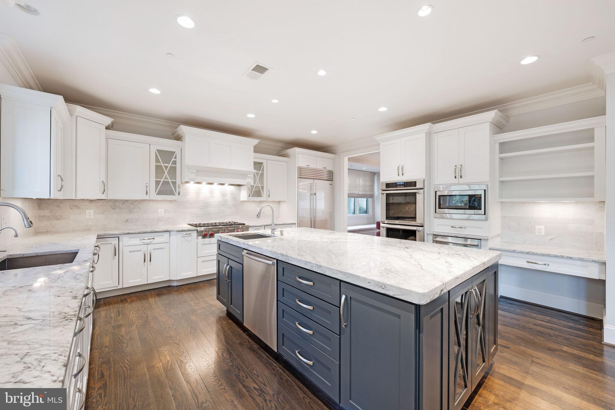 8505 Rayburn Road Bethesda, MD 20817 - Photo 3 of 49 a kitchen with stainless steel appliances granite countertop a kitchen island a stove a sink and a refrigerator