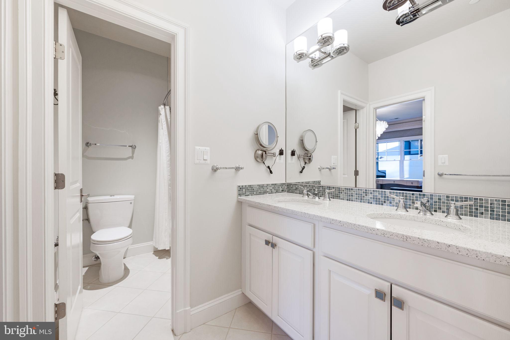 8505 Rayburn Road Bethesda, MD 20817 - Photo 39 of 49 a bathroom with a granite countertop sink a toilet and a mirror