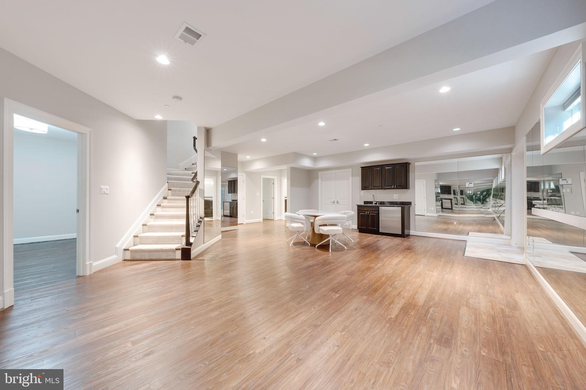 8505 Rayburn Road Bethesda, MD 20817 - Photo 40 of 49 a view of a living room and a kitchen with wooden floor