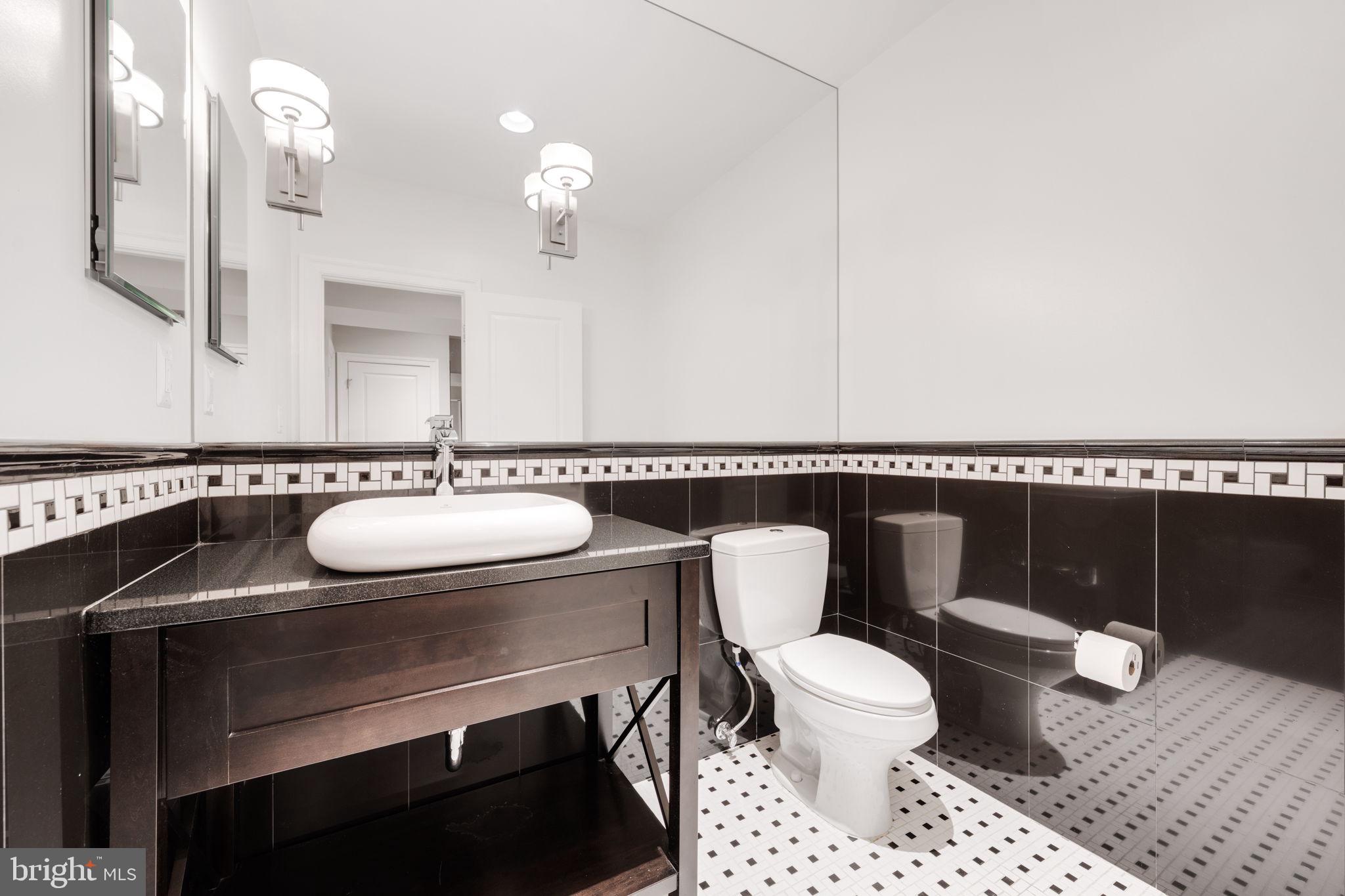 8505 Rayburn Road Bethesda, MD 20817 - Photo 42 of 49 a bathroom with a sink a toilet and a mirror