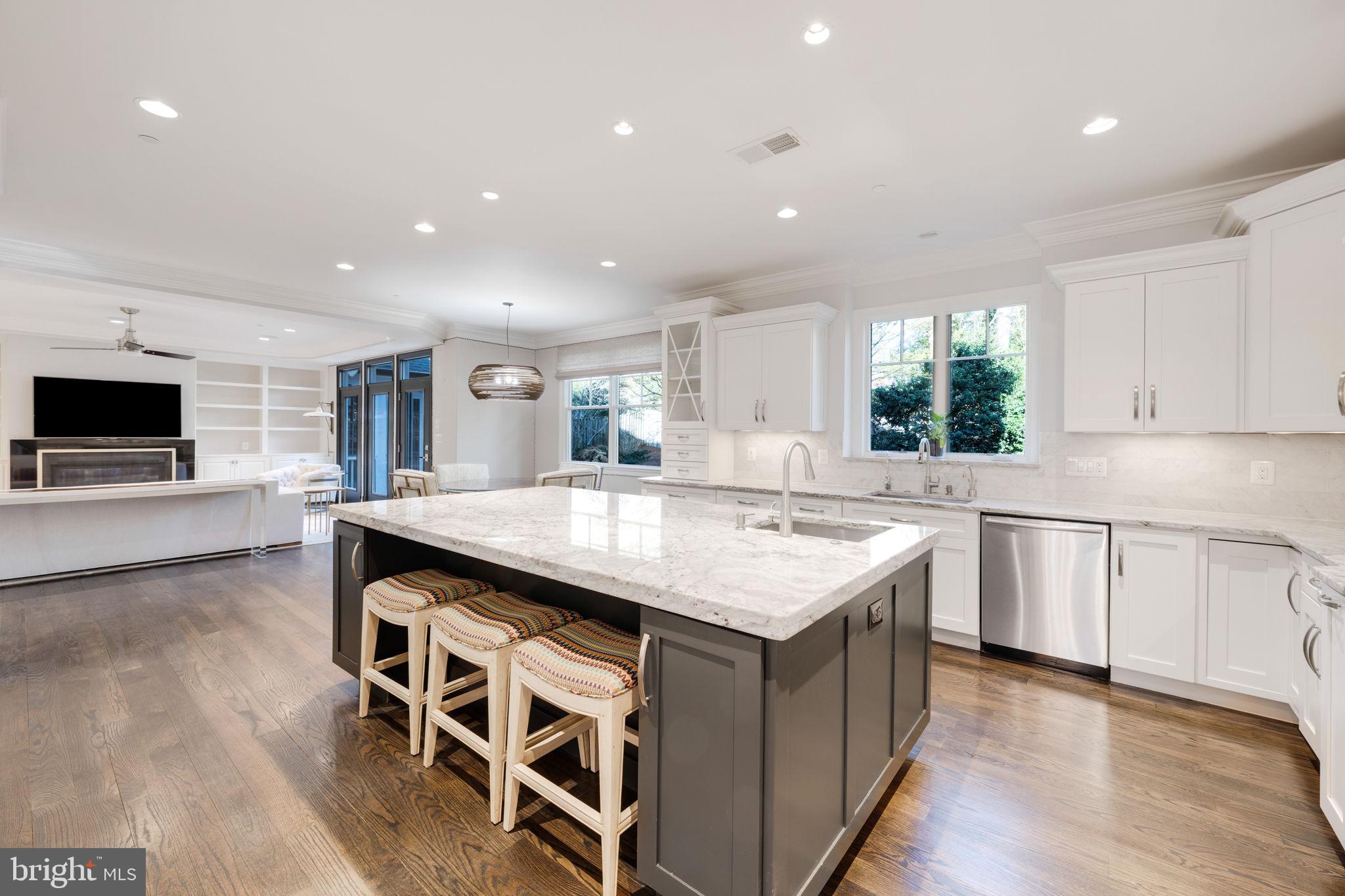 8505 Rayburn Road Bethesda, MD 20817 - Photo 5 of 49 a large kitchen with kitchen island a sink table and chairs