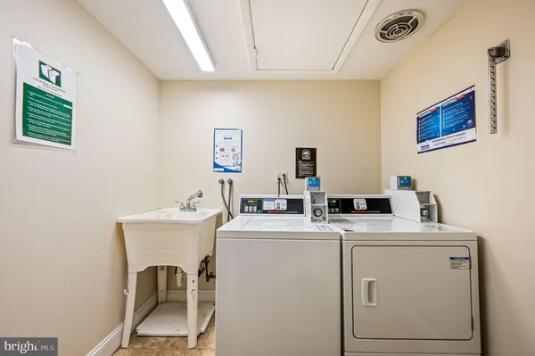 a utility room with dryer washer and sink
