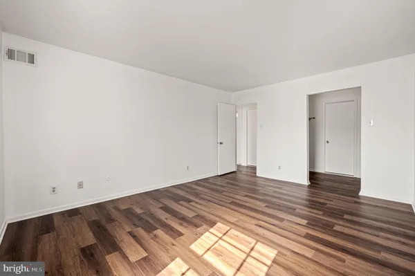 a view of an empty room and wooden floor
