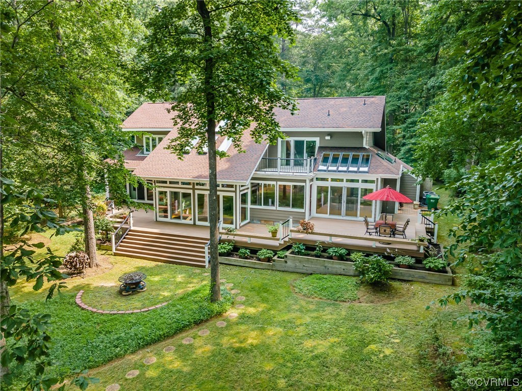 a front view of a house with swimming pool table and chairs