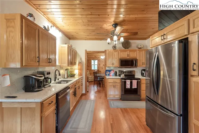 a kitchen with stainless steel appliances a stove sink microwave and cabinets