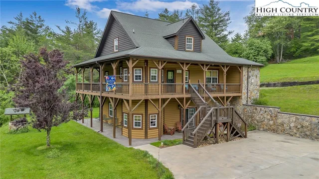 a view of a big house with large trees and a big yard