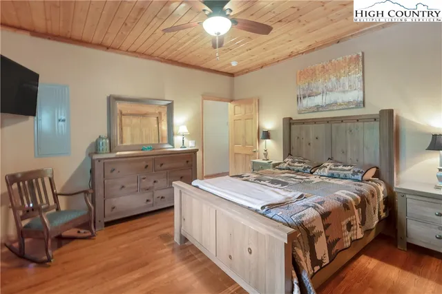 a bedroom with a large bed and a large window