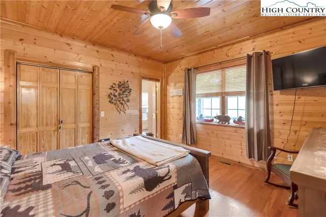 a bedroom with a large bed and a large window