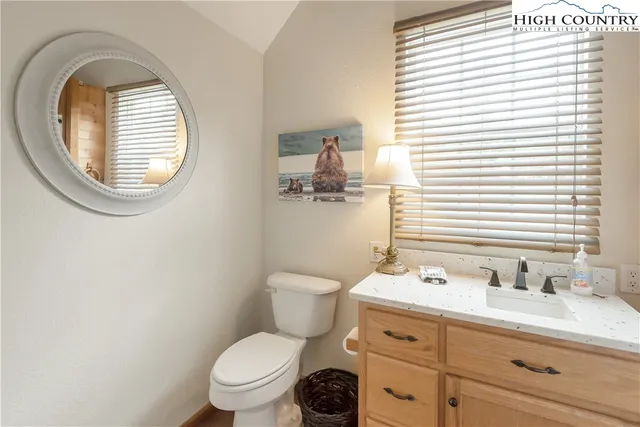 a bedroom with a bed and a night stand