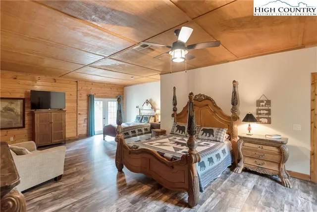 a view of a hallway with wooden floor and chandelier