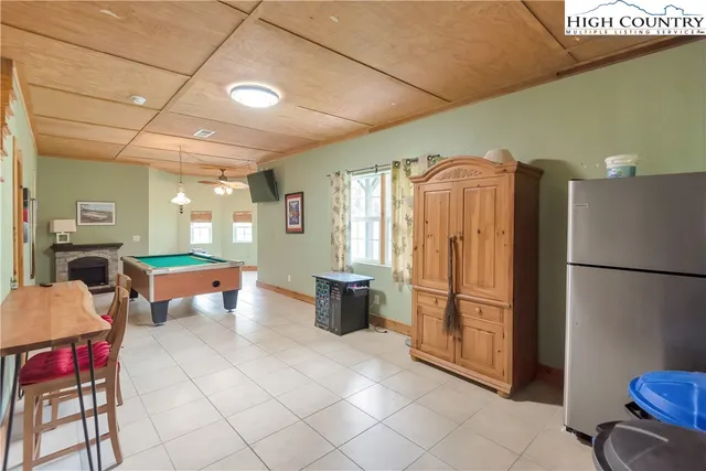 a room with pool table and windows