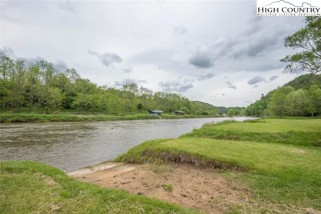 a view of a green field with wooden fence
