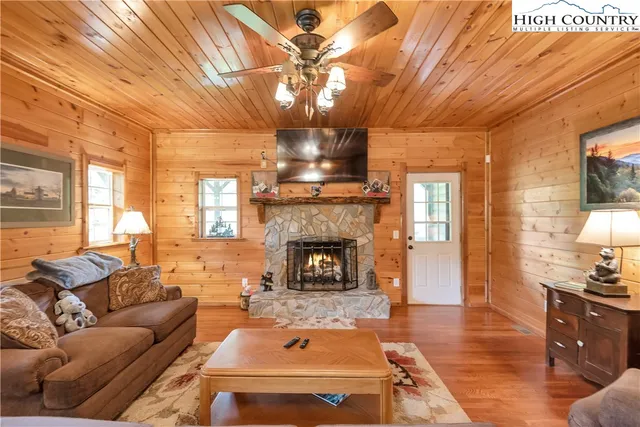 a living room with furniture a rug and a chandelier