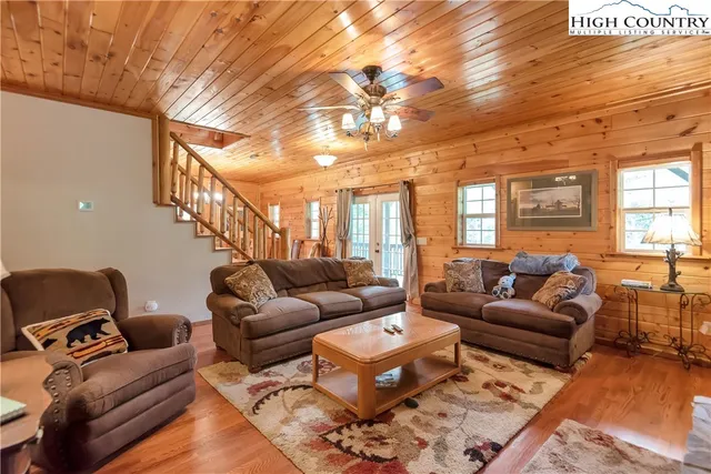 a living room with furniture a rug and a chandelier