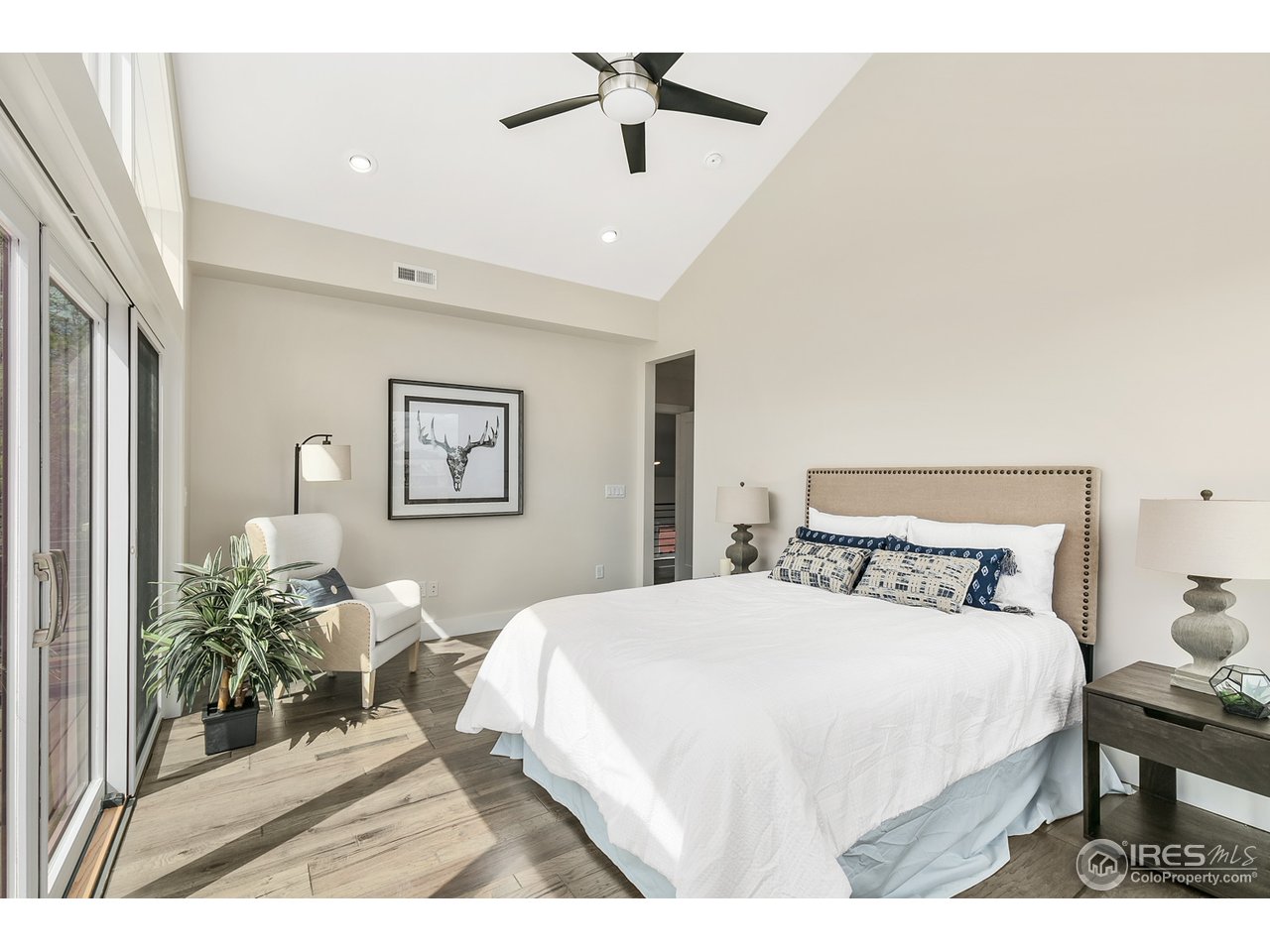 2800 10th Street Boulder, CO 80304 - Photo 21 of 40 a bedroom with a bed and a chandelier