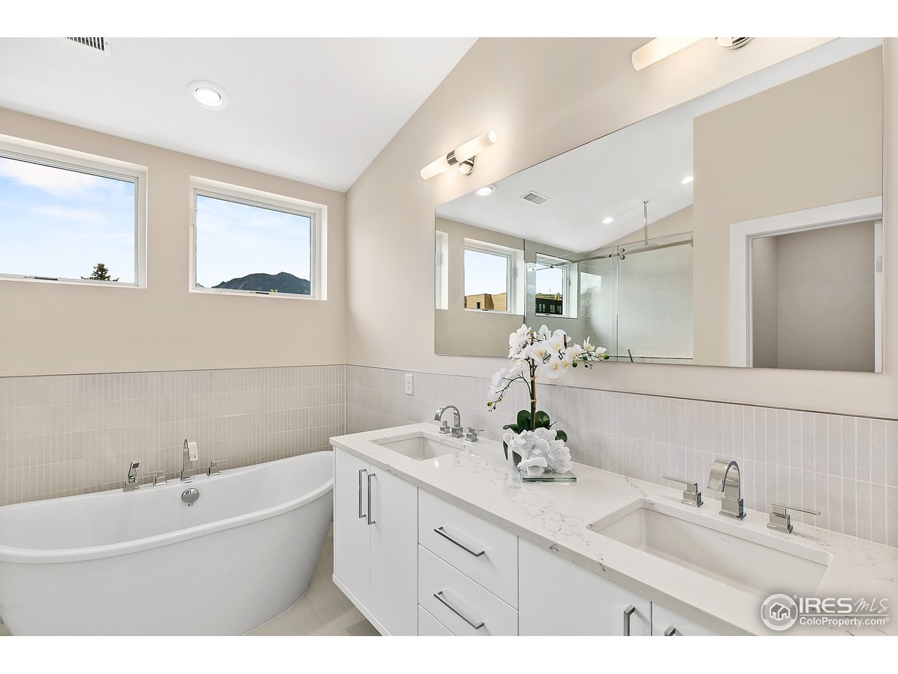 2800 10th Street Boulder, CO 80304 - Photo 25 of 40 a bathroom with a double vanity sink mirror and bathtub