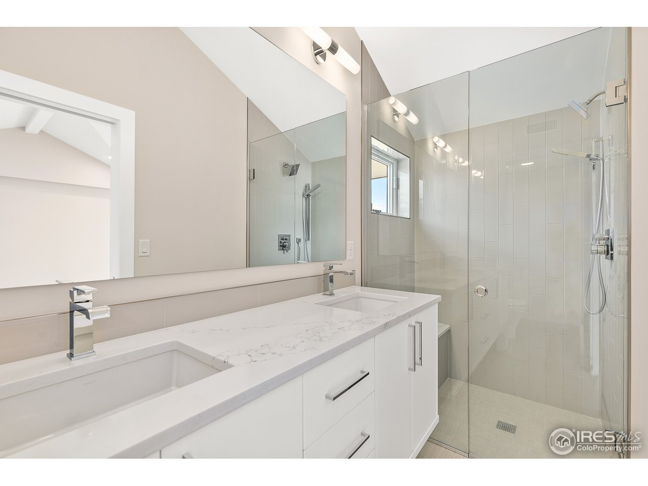2800 10th Street Boulder, CO 80304 - Photo 32 of 40 a bathroom with a sink a vanity a mirror and shower