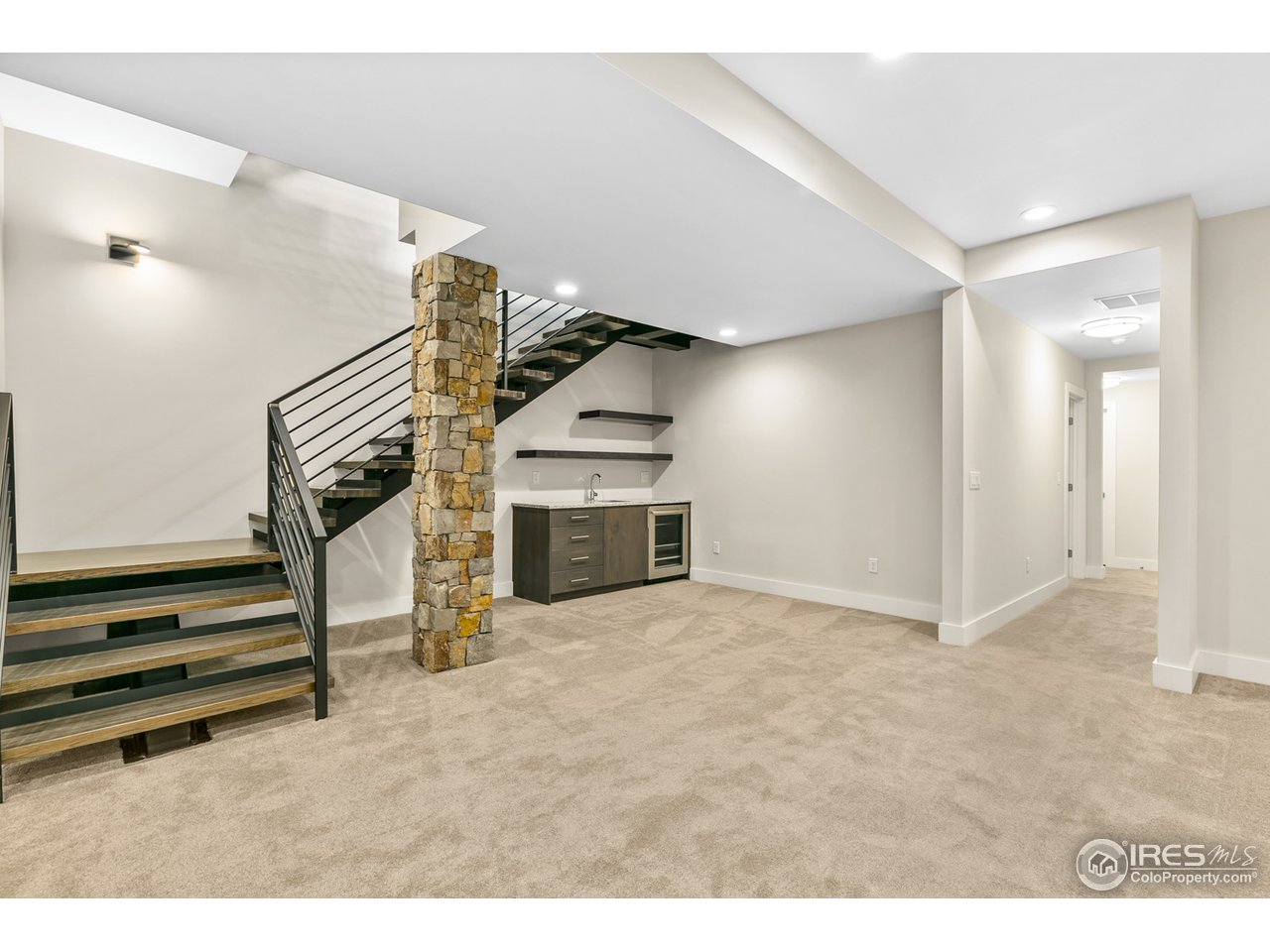 2800 10th Street Boulder, CO 80304 - Photo 33 of 40 a view of an empty room with stairs wooden floor and a cabinet