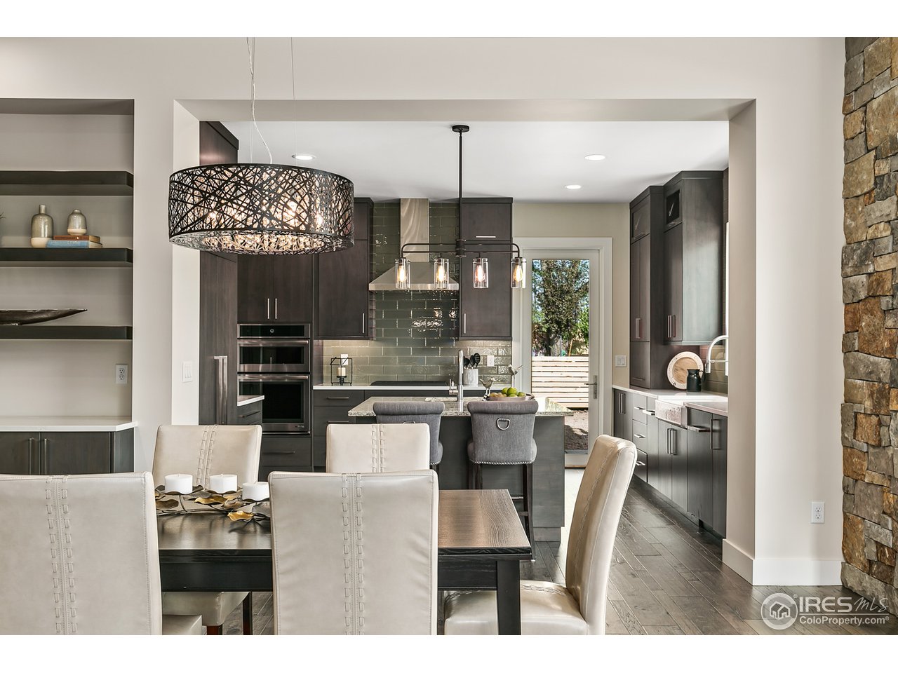 2800 10th Street Boulder, CO 80304 - Photo 8 of 40 a kitchen with stainless steel appliances kitchen island granite countertop a table and chairs in it