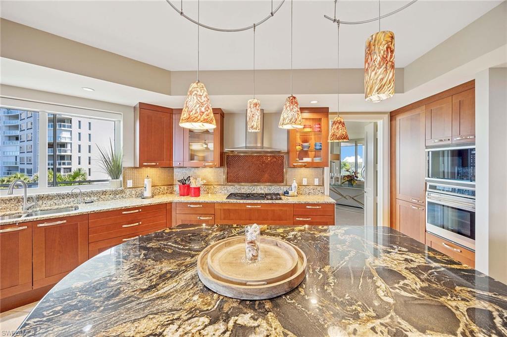 13675 Vanderbilt Drive, Unit 510 Naples, FL 34110 - Photo 12 of 37 a bathroom with a granite countertop sink and a mirror