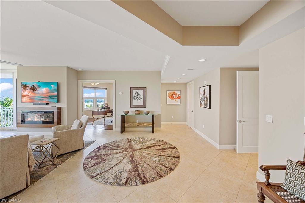 13675 Vanderbilt Drive, Unit 510 Naples, FL 34110 - Photo 20 of 37 a living room with furniture and wooden floor