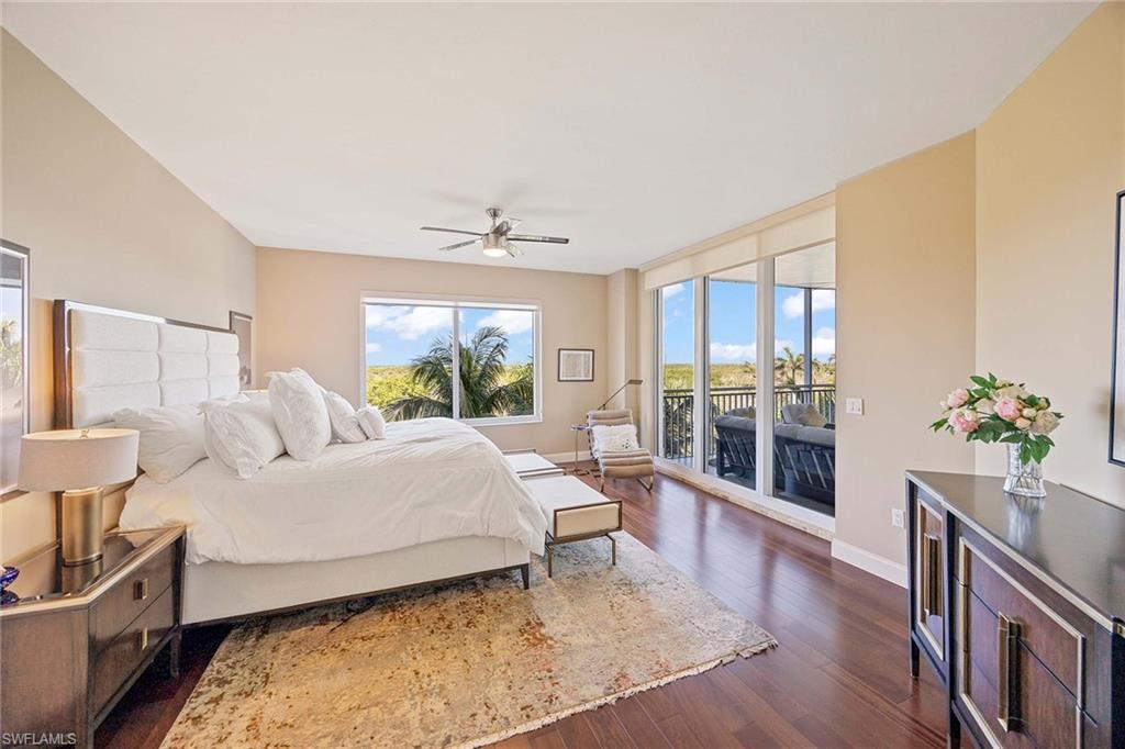 13675 Vanderbilt Drive, Unit 510 Naples, FL 34110 - Photo 21 of 37 a bed room with a bed and a potted plant