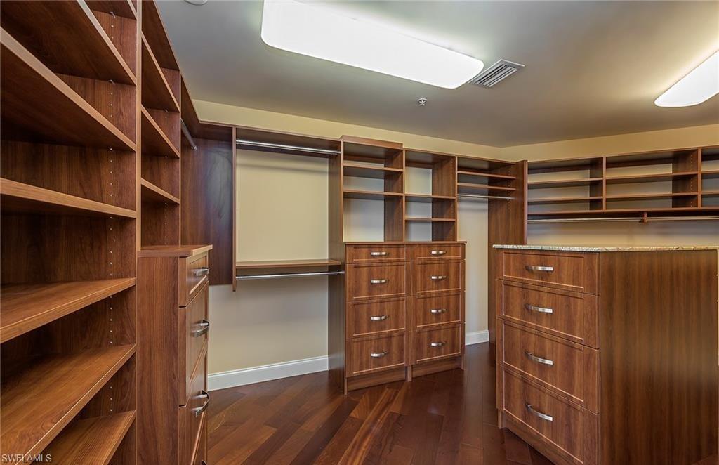 13675 Vanderbilt Drive, Unit 510 Naples, FL 34110 - Photo 23 of 37 a view of walk in closet with clothes and shoes