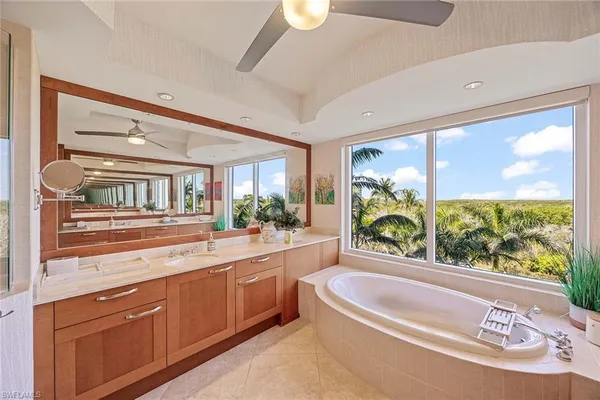 a large white kitchen with a large window