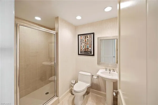 a bathroom with a toilet sink and shower