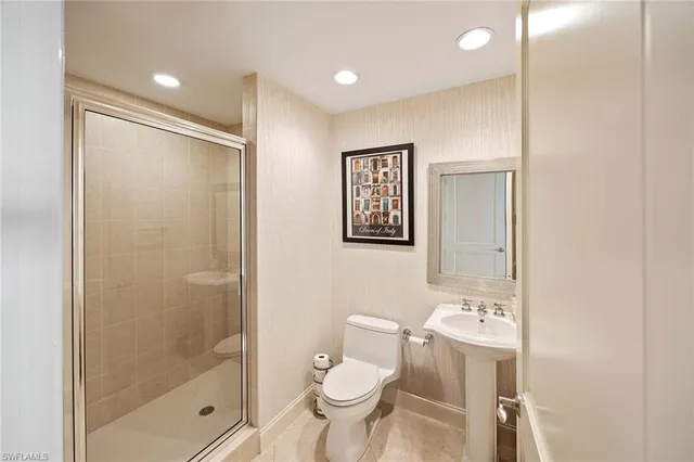 a bathroom with a toilet sink and shower