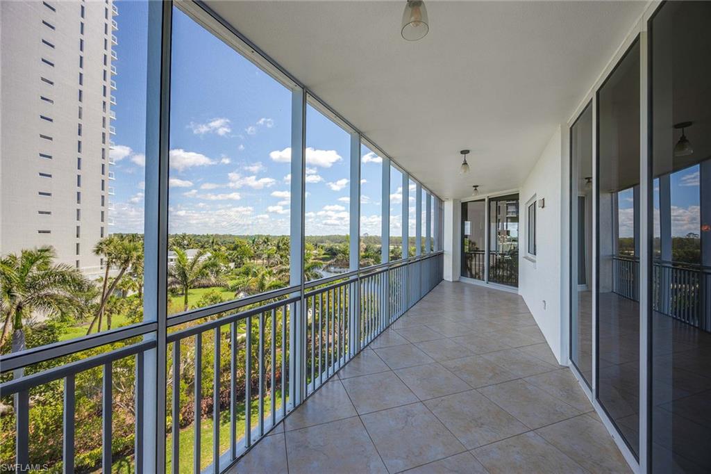13675 Vanderbilt Drive, Unit 510 Naples, FL 34110 - Photo 34 of 37 a view of a city from a balcony