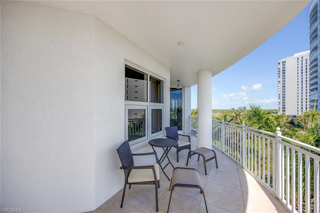 13675 Vanderbilt Drive, Unit 510 Naples, FL 34110 - Photo 37 of 37 a view of a chairs and table in a balcony