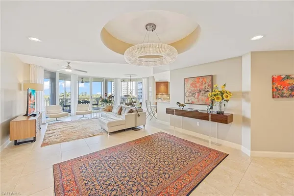 a living room with furniture and a chandelier