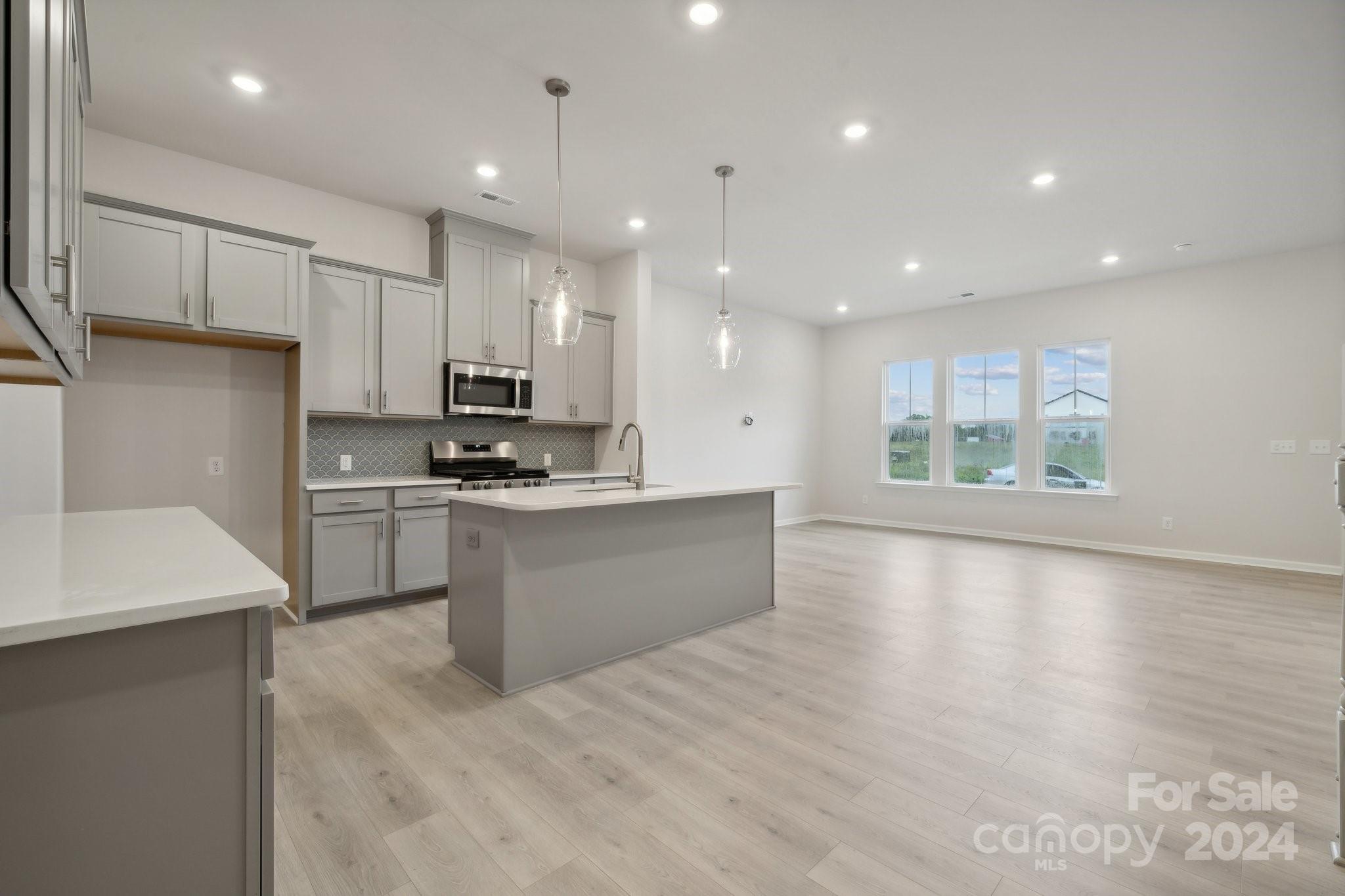 8610 Miles Gap Road Indian Land, SC 29707 - Photo 5 of 26 a kitchen with a sink stainless steel appliances and cabinets