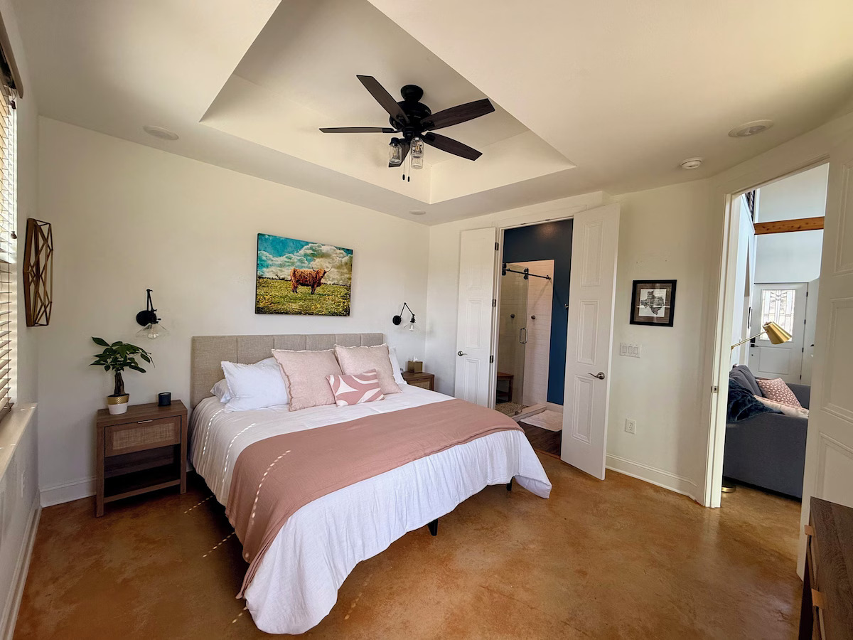 11605 Fitzhugh Road Austin, TX 78736 - Photo 16 of 24 a bedroom with a bed and a ceiling fan