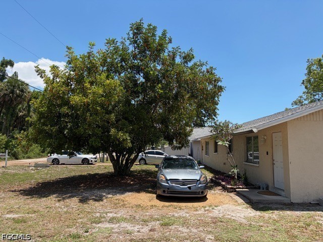 2175 Twin Brooks Road North Fort Myers, FL 33917 - Photo 14 of 27 a view of a backyard with table and chairs and a fire pit
