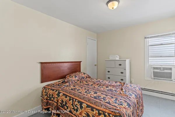 a bedroom with a bed and cabinets