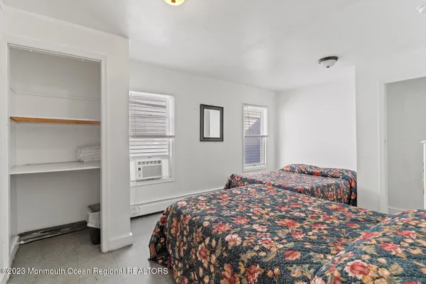 a bedroom with a bed and painting on the wall