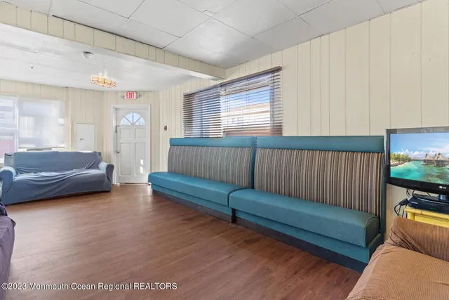 a bedroom with two beds and a lamp on dresser