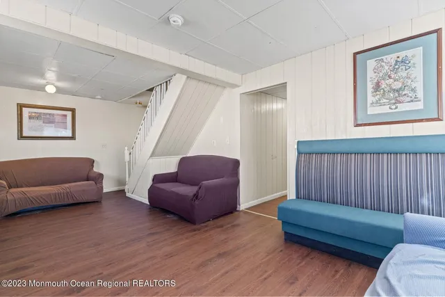 a bedroom with a bed and a lamp on the dresser